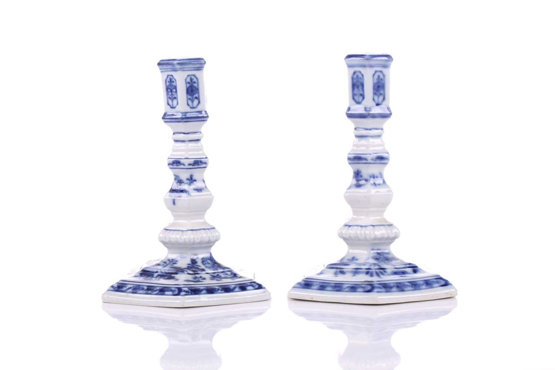 A pair of Meissen porcelain 'Onion' pattern Dutch style squat candlesticks of hexagonal section,