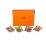 A presentation boxed Hermes of Paris set of four porcelain individual ashtrays in colours with