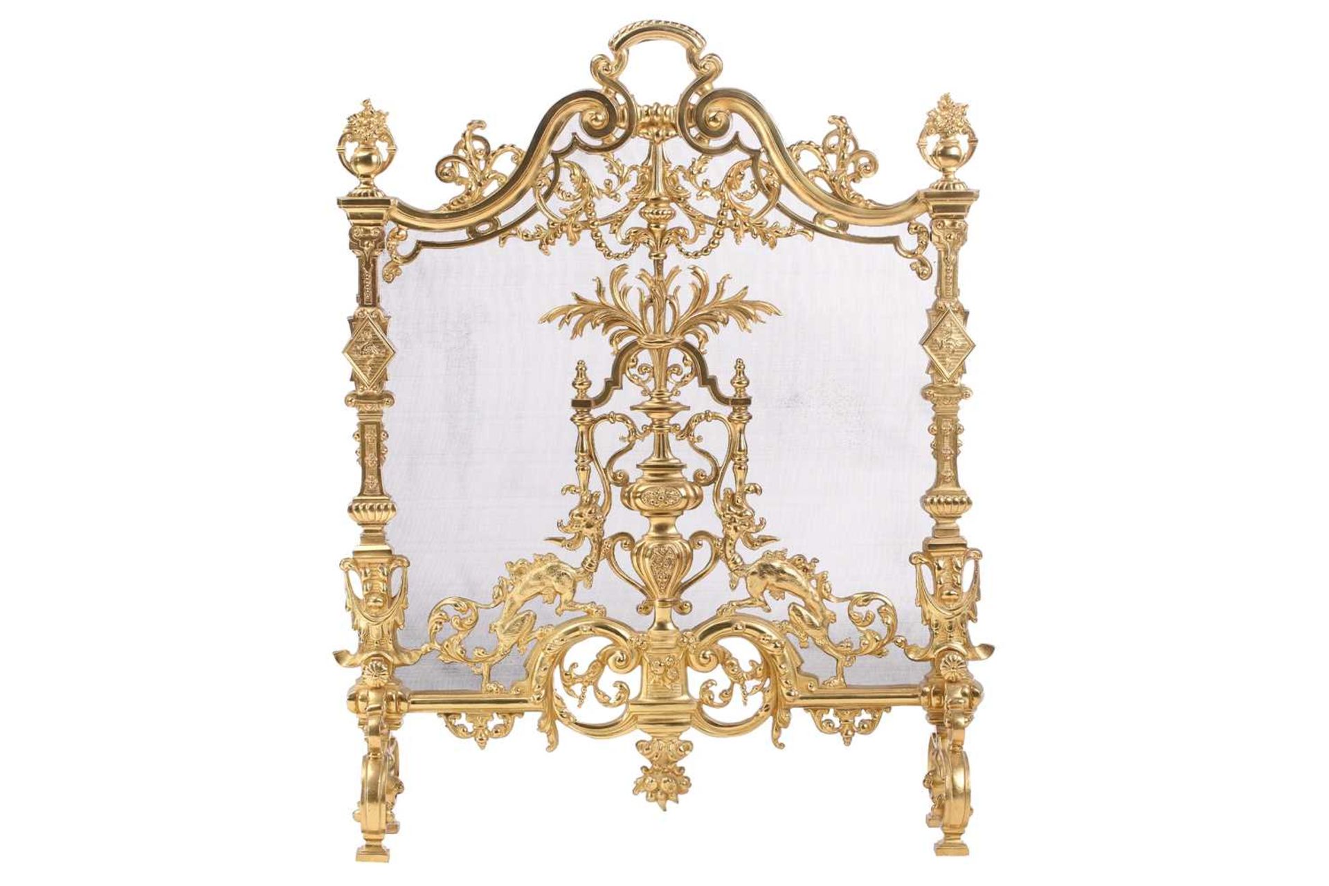 A Louis XVI-style heavy ormolu spark guard, late 20th century, with a shaped arch top above a pieced