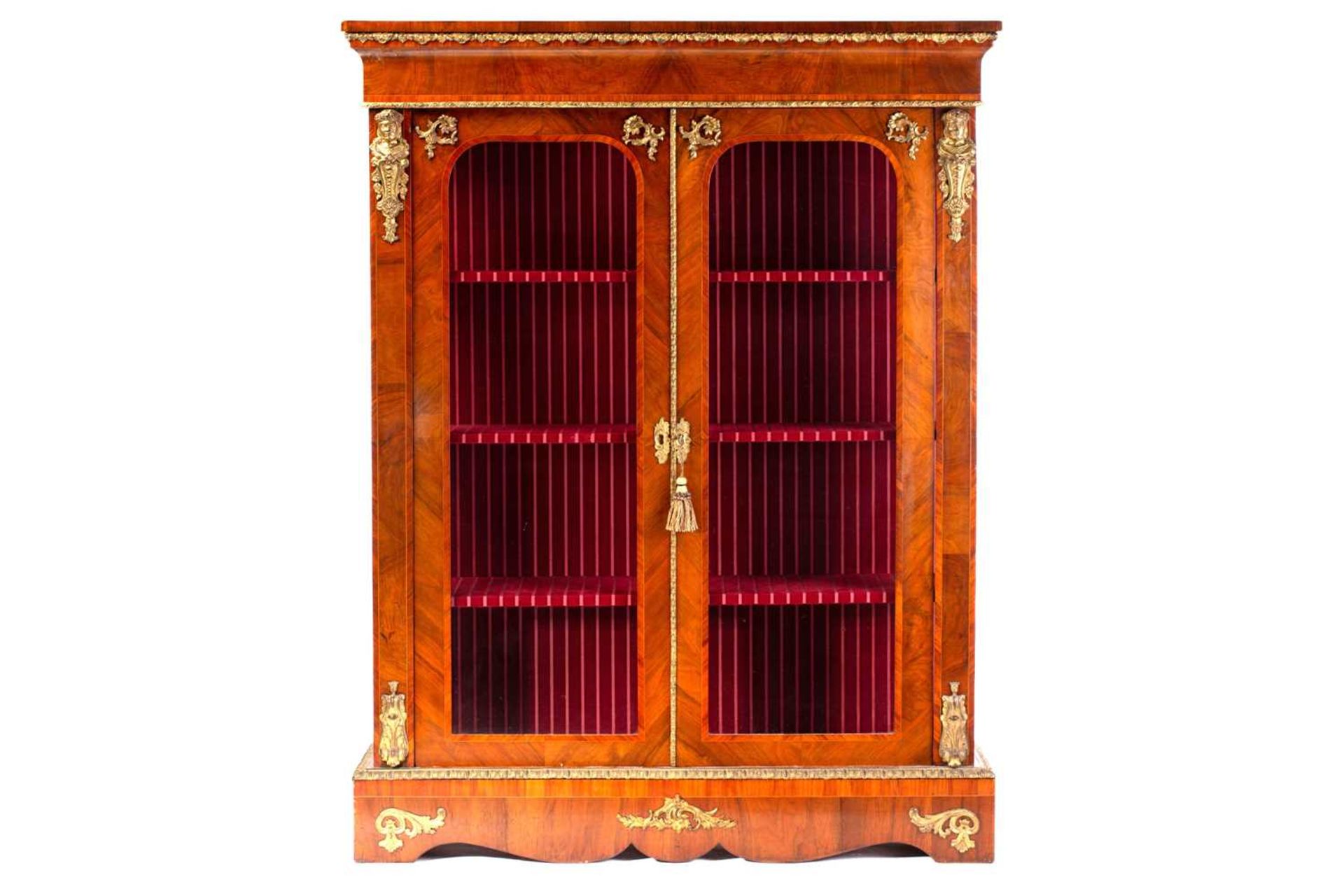 A Victorian French style two door figured walnut vitrine, with satin wood stringing and tulipwood