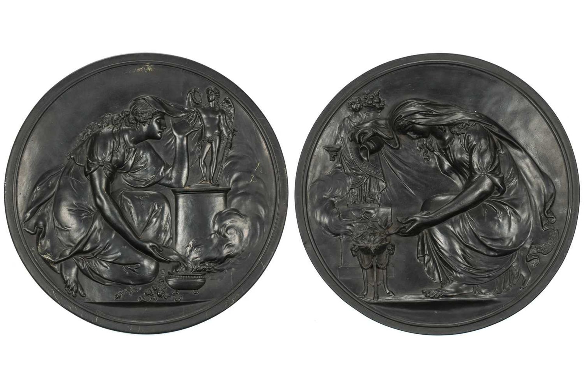 A pair of large late 19th century Wedgwood black basalt circular plaques, depicting neo-classical