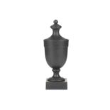 Wedgwood & Bentley, Etruria: a late 18th century black basalt urn and cover, of plain form on a