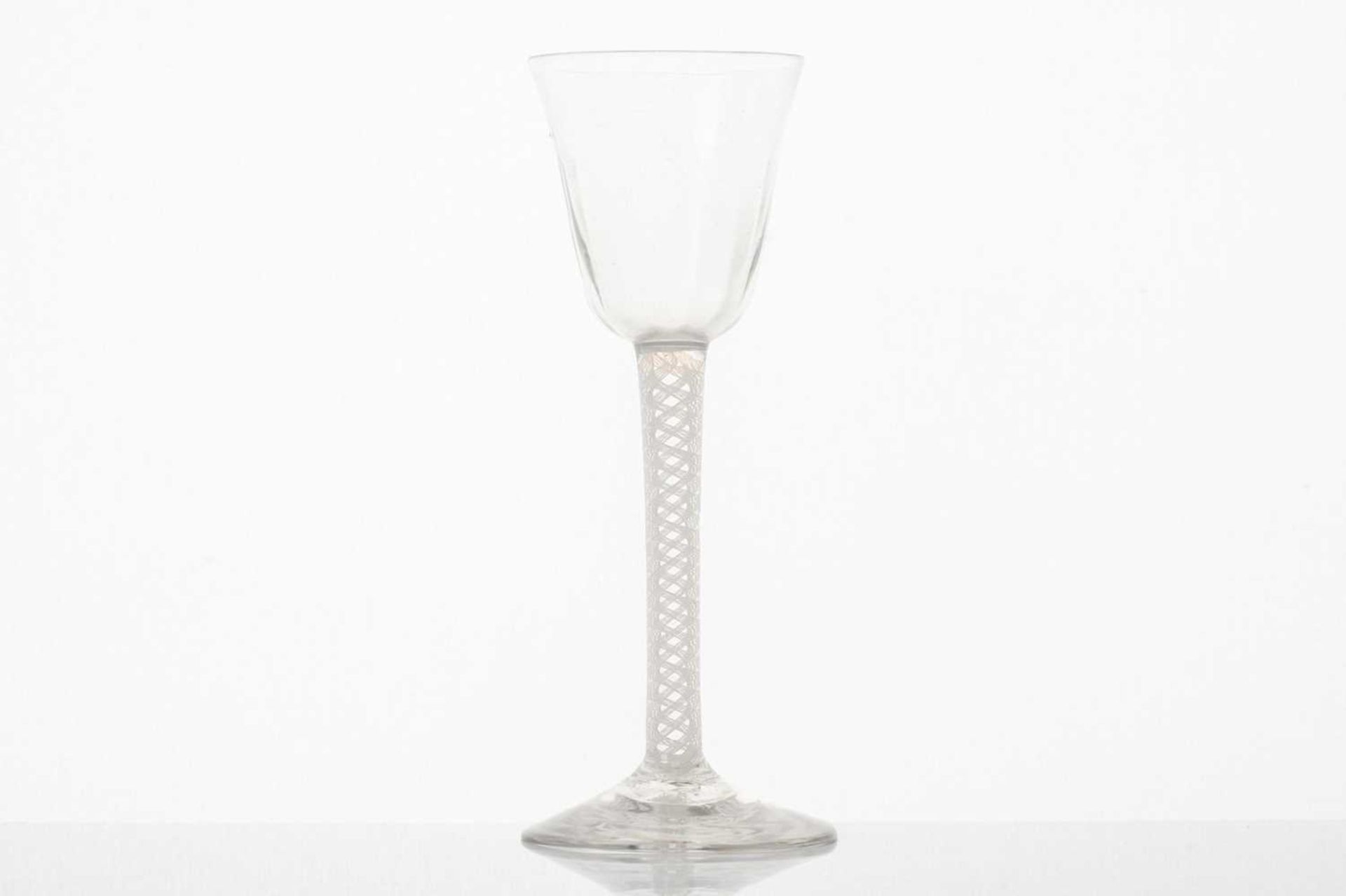 An 18th-century wine glass, the conical bowl over a twin thread opaque air twist stem and conical - Image 3 of 5