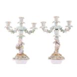 A pair of German porcelain figural three sconce candelabra, with tre stum stems mounted with a