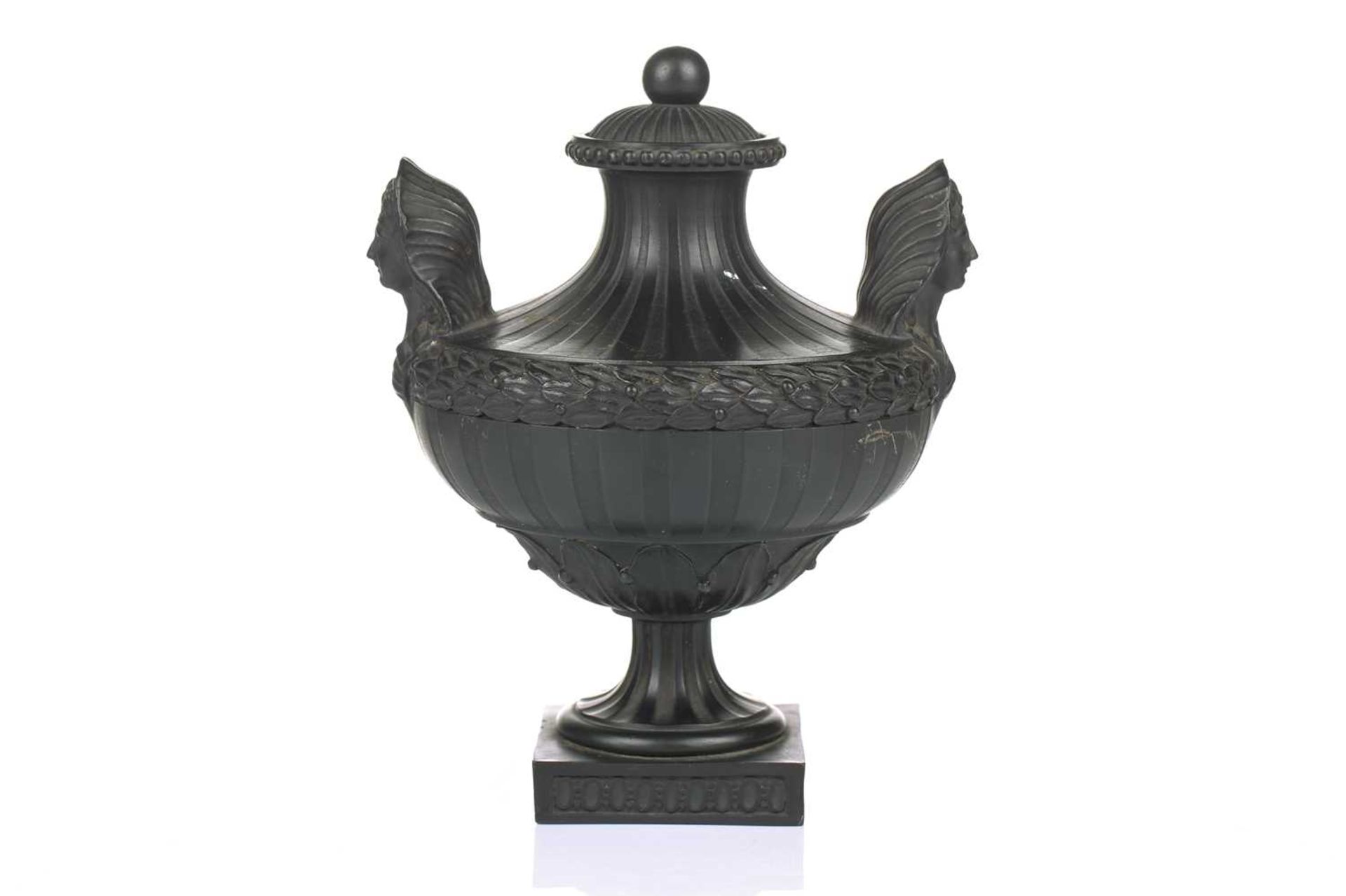 Wedgwood & Bentley, Etruria: a late 18th century black basalt urn and cover, of Classical form