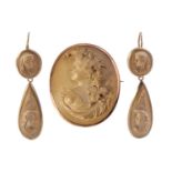 A Victorian lava cameo demi-parure; comprising a brooch and a pair of pendant earrings; with