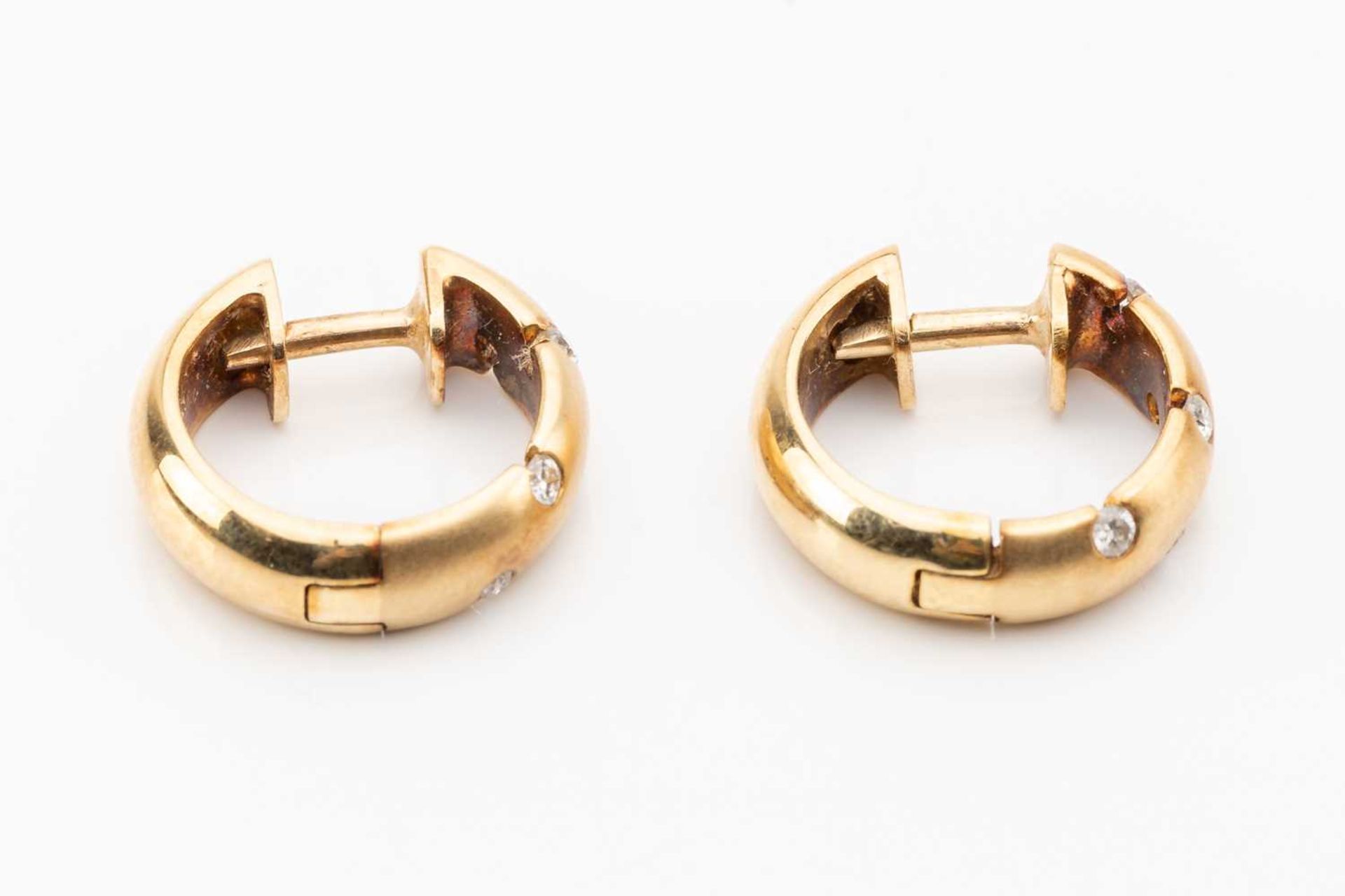 A pair of diamond set huggy hoop earrings, featuring sunk set round brilliant cut diamond in - Image 2 of 4