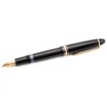 A Mont Blanc Meisterstück 146 fountain pen, with twist black resin barrel, gold-tone hardware, and