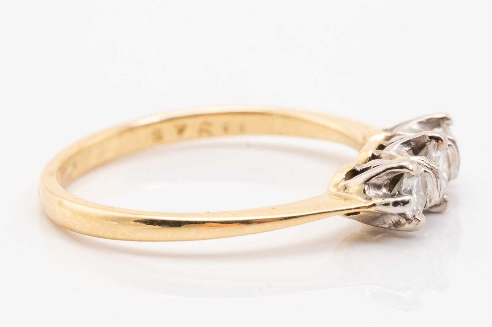 A yellow gold and diamond three stone half hoop diamond ring; the slightly graduated round brilliant - Image 2 of 5