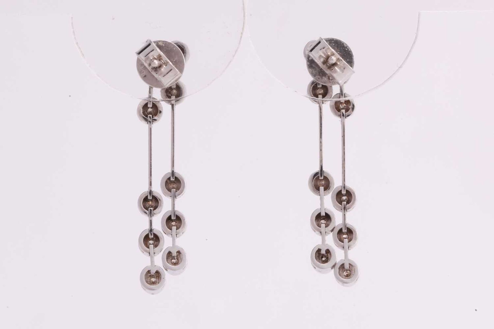 A pair of diamond drop earrings in 18ct white gold, each containing two lines of articulated - Image 2 of 3