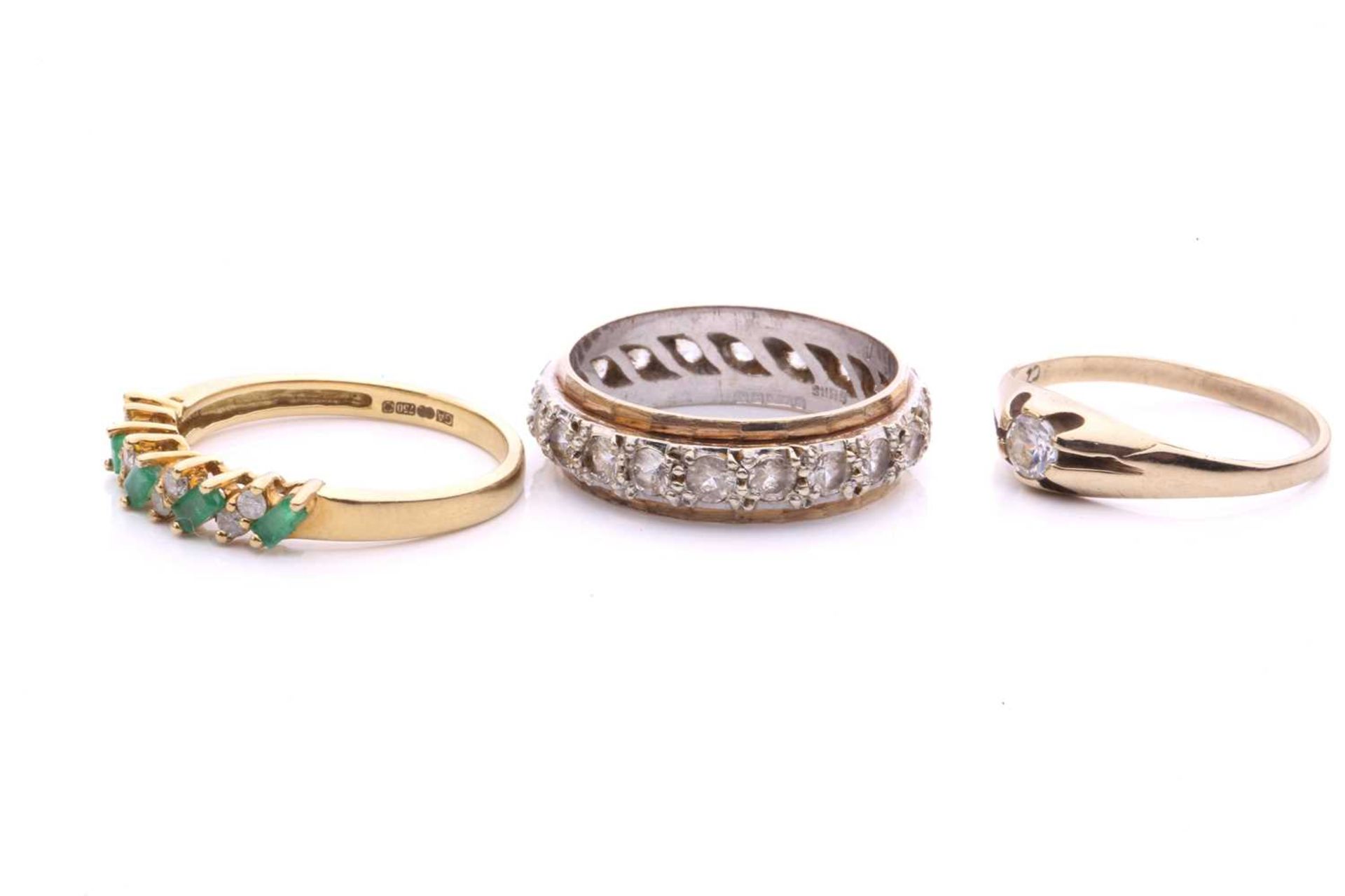 Three gem-set rings in gold; to include an 18ct gold ring set with alternating emeralds and - Image 3 of 4