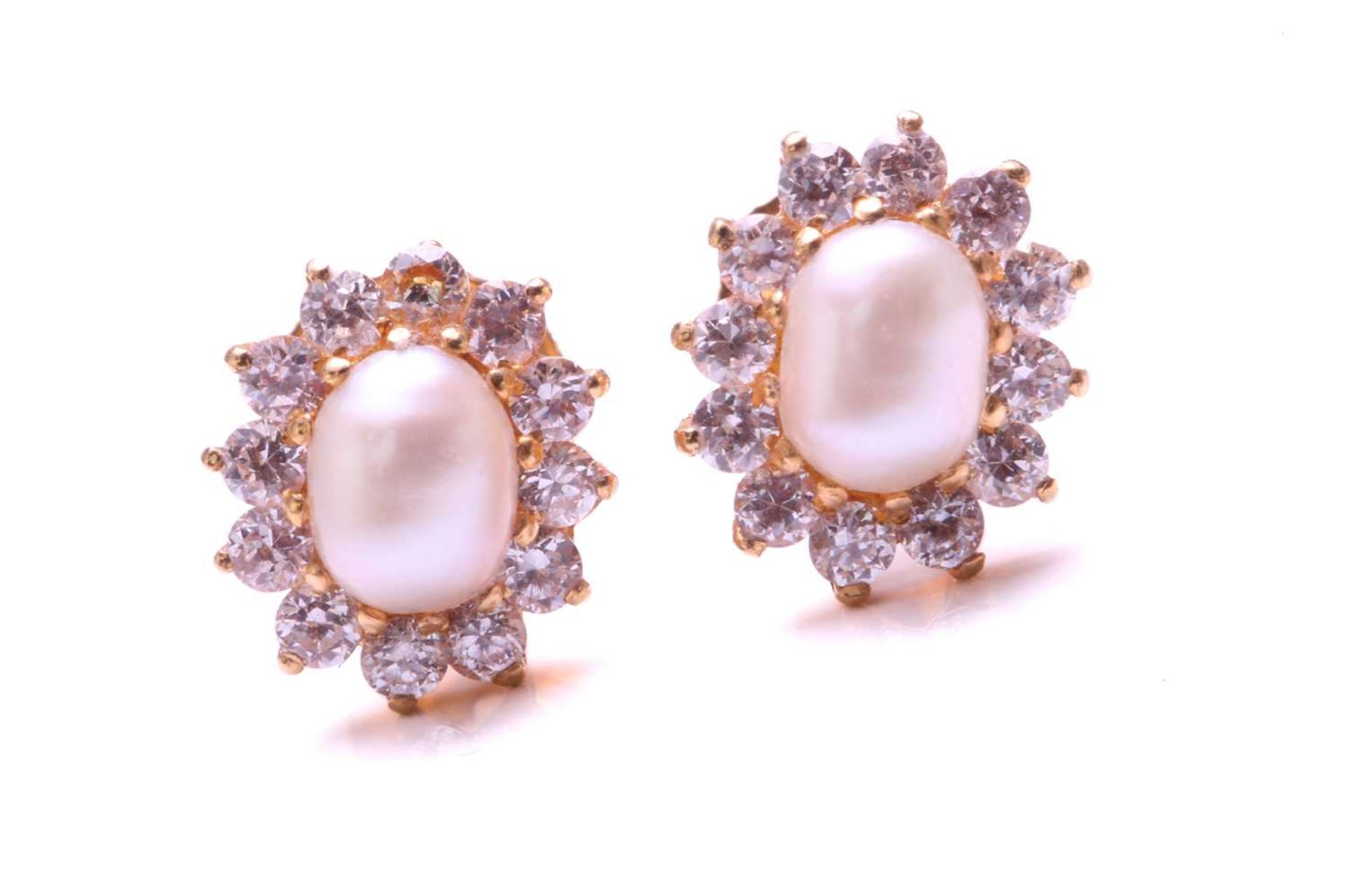 A pair of pearl and cubic zirconia cluster earrings in high-carat gold, each features an oval-shaped