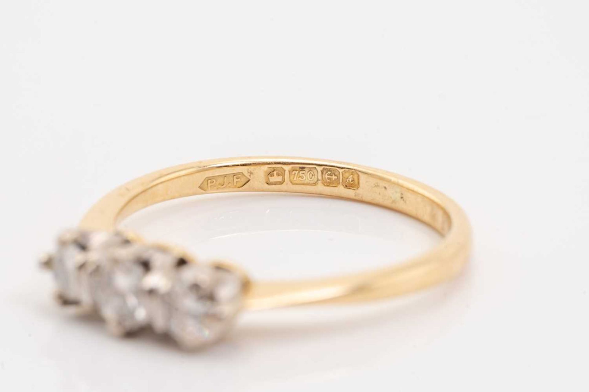 A yellow gold and diamond three stone half hoop diamond ring; the slightly graduated round brilliant - Image 4 of 5