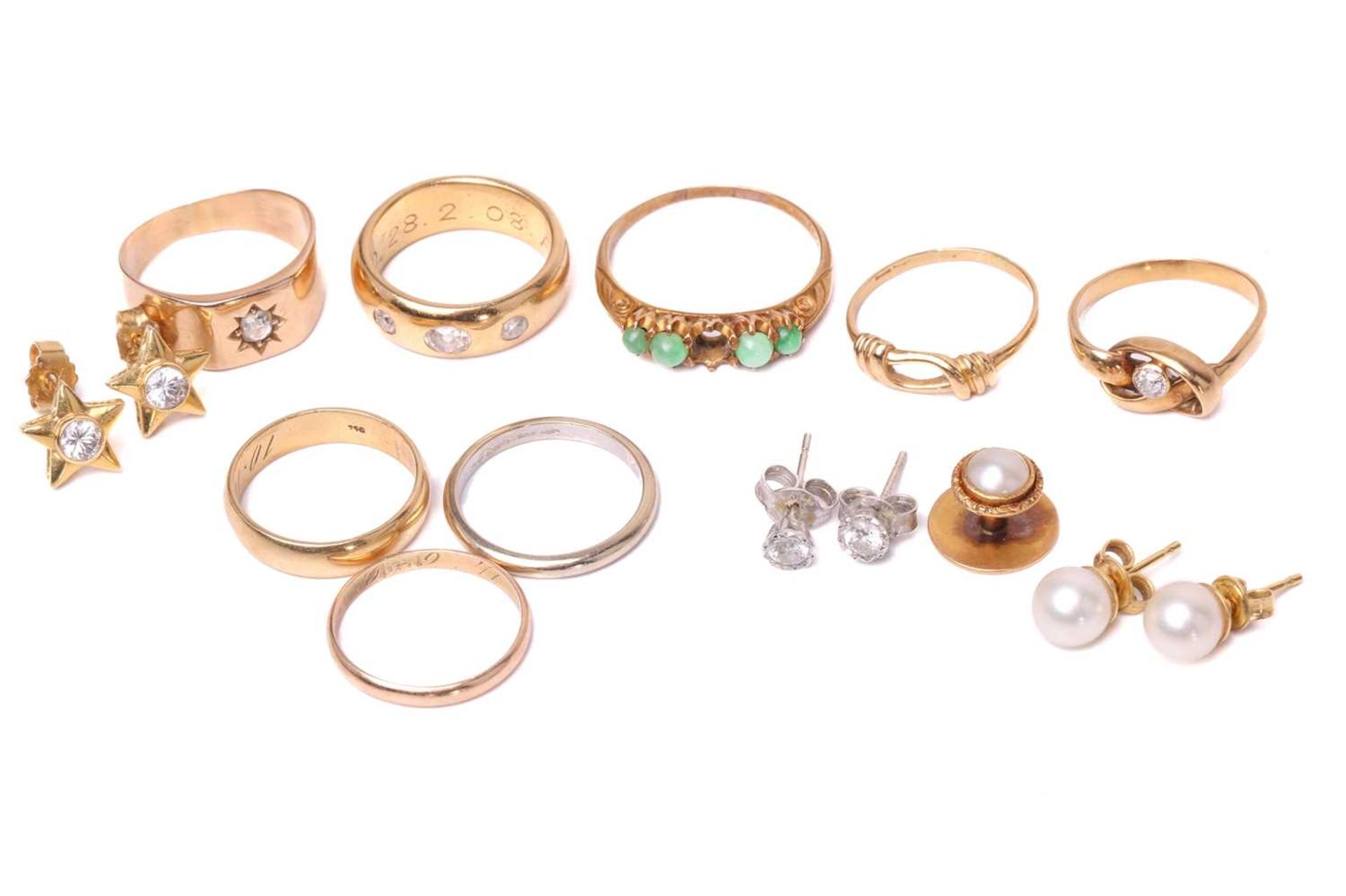 A collection of rings and three pairs of stud earrings; including a three-stone gypsy ring with