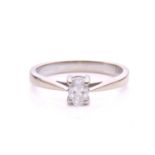 A diamond solitaire ring in 18ct white gold, consisting of an oval-cut diamond with an estimated