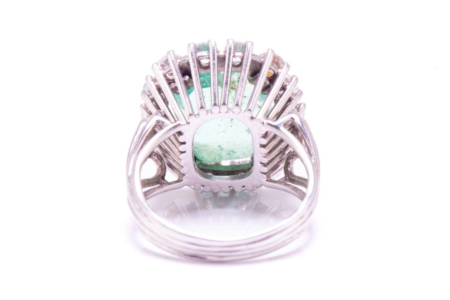 An emerald and diamond entourage ring, centred with an emerald-cut emerald of pale bright bluish- - Image 5 of 12