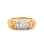 An 18 carat gold and diamond ring saddle ring; the curved centre panel pavé set with brilliant cut
