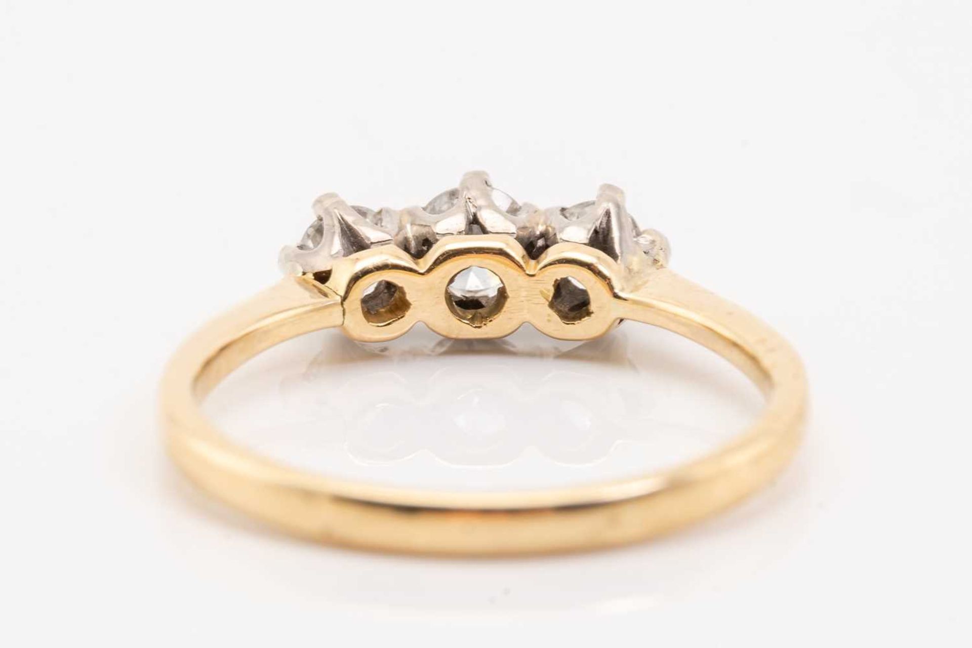 A yellow gold and diamond three stone half hoop diamond ring; the slightly graduated round brilliant - Image 5 of 5