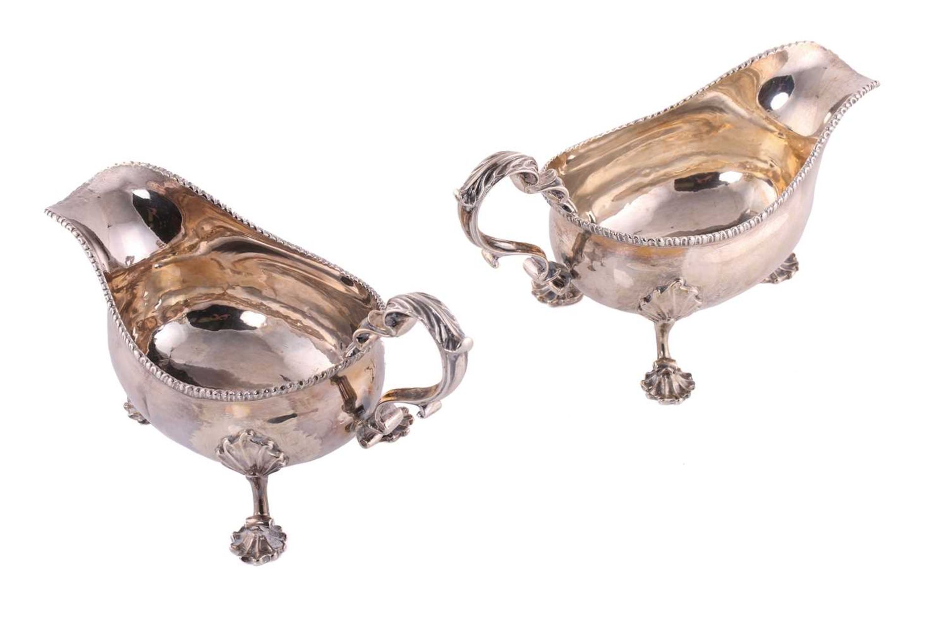 A pair of George II silver sauce boats; with gadrooned borders and leaf capped double scroll - Image 2 of 12