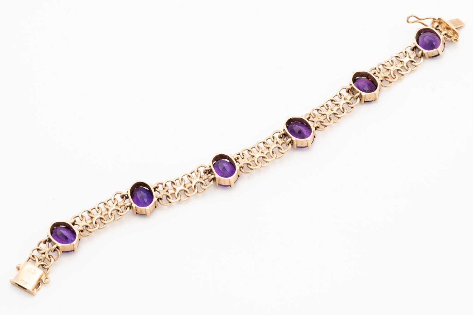 A bracelet set with amethysts in 9ct gold, comprising a wide bismarck link with six oval-cut - Image 3 of 5