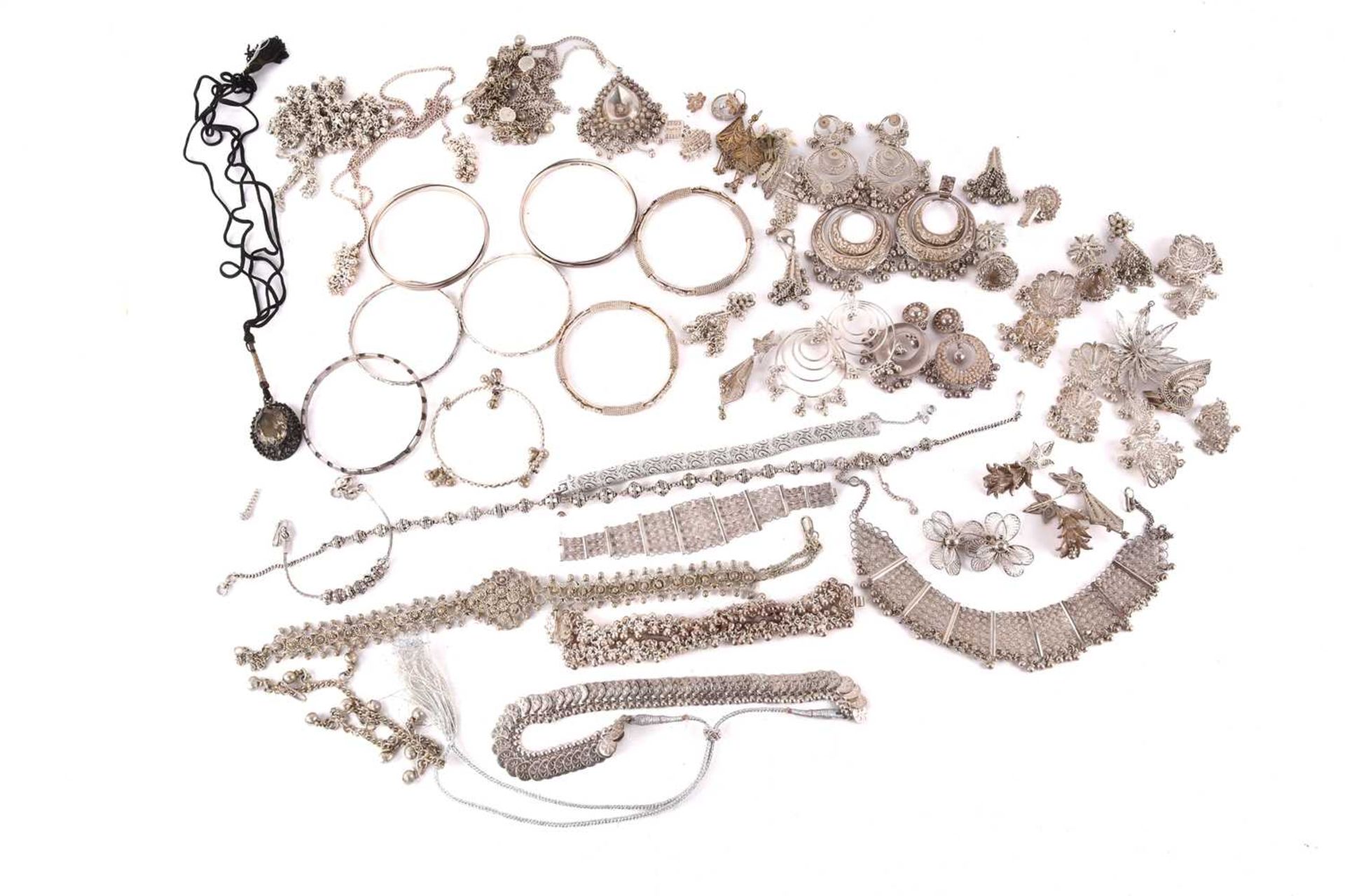 A large collection of white metal and base metal jewellery, including eight bangles, filagree