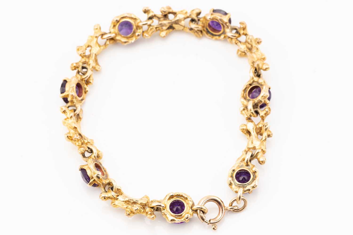 A seven stone amethyst bracelet, the circular cut stones set in claw mounts between textured - Image 4 of 4