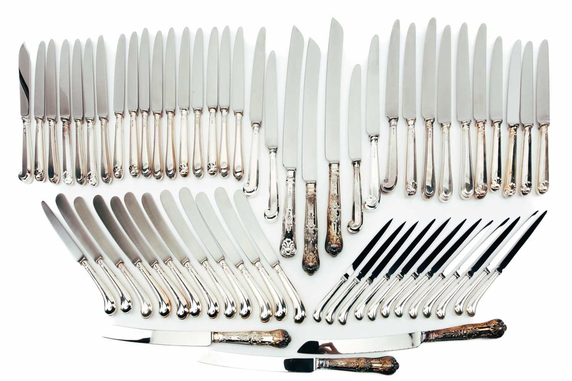 A mixed collection of various modern silver-handled knives, some with pistol grip handles