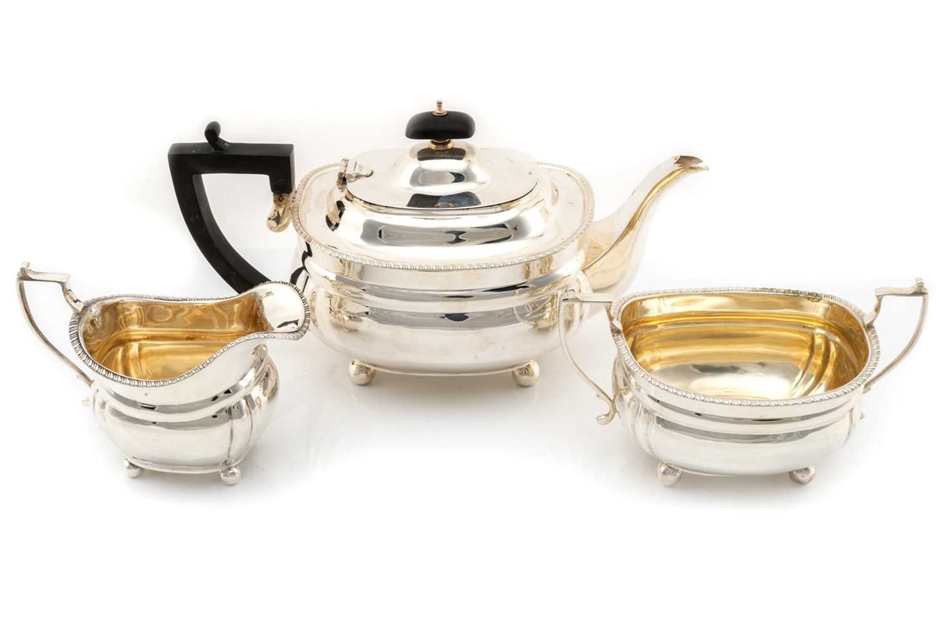 An early 20th-century silver three-piece teaset, London 1917 makers marks indistinct, the oval squat