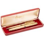 Asprey. A cased 9 carat gold ball point pen and pencil, bark finish engine-turned bodies. The pen