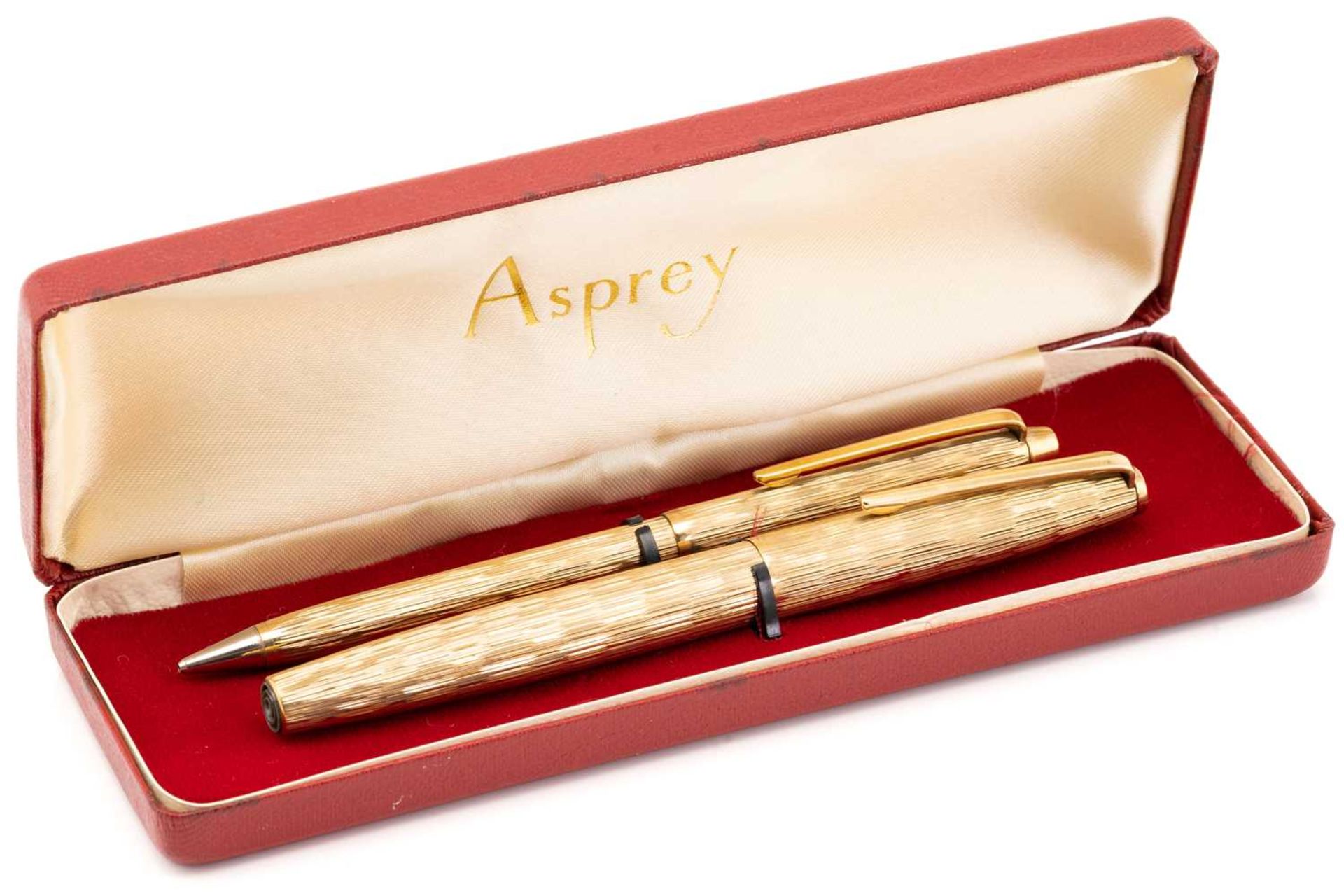 Asprey. A cased 9 carat gold ball point pen and pencil, bark finish engine-turned bodies. The pen