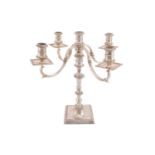 A 20th century silver four branch candelabra, London 1982 by A Haviland-Nye, on a square raised base