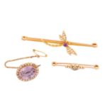 Three gem-set brooches with seed pearls; the first contains an oval-cut amethyst with pale purple