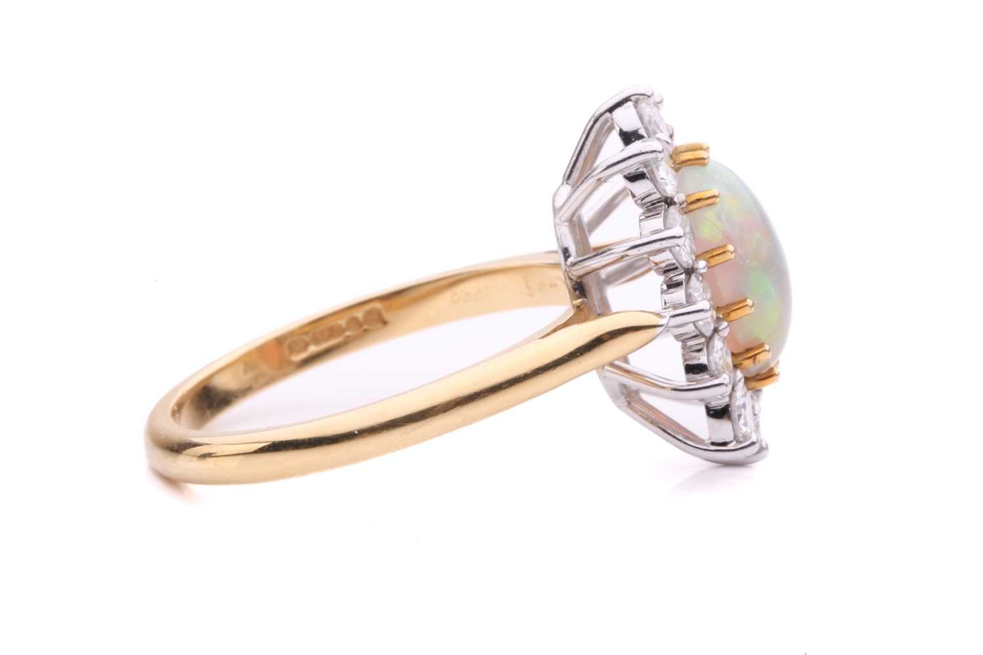 An opal and diamond entourage ring in 18ct gold, featuring an oval precious opal cabochon of 9.2 x - Image 3 of 5