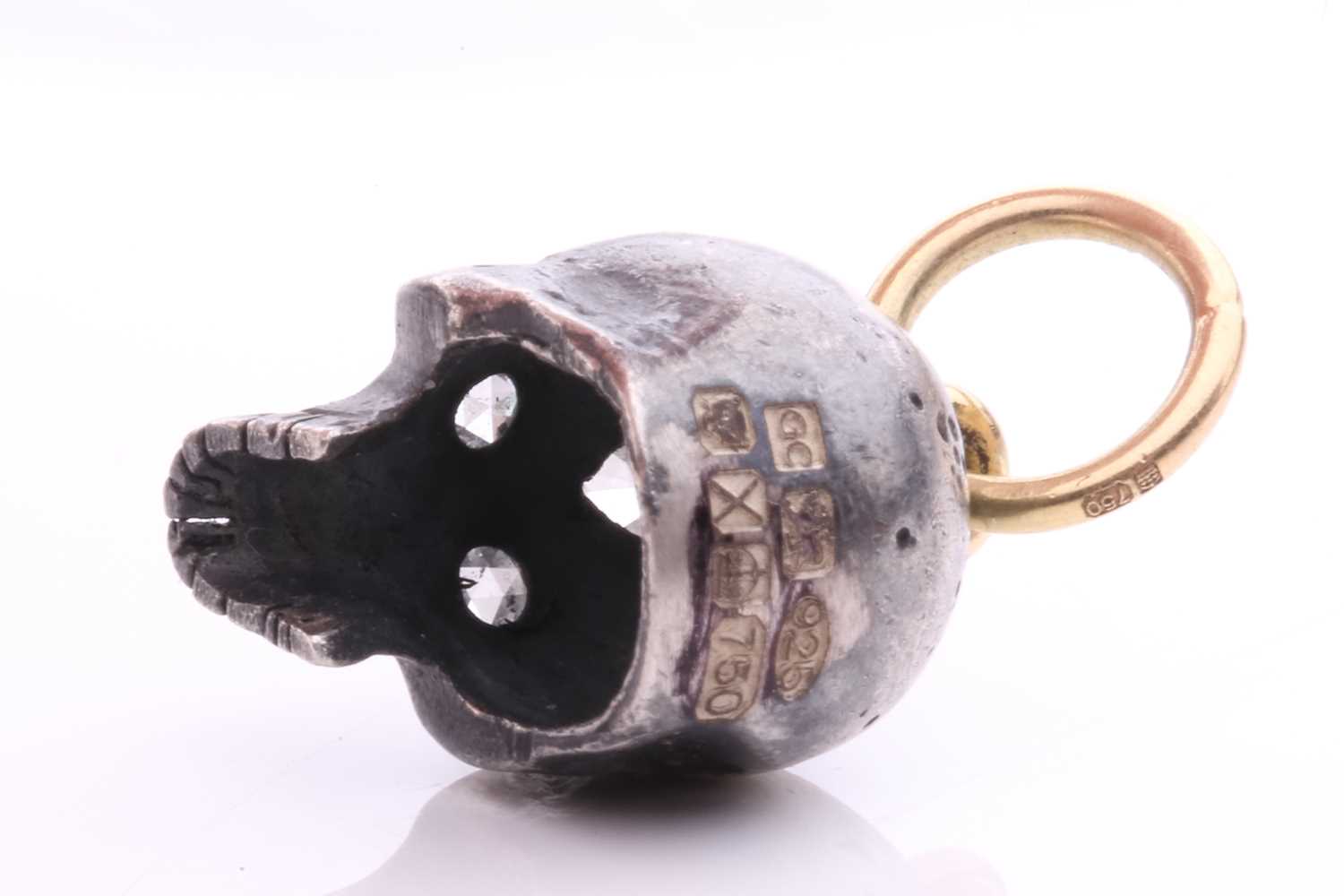 A diamond-set skull charm pendant in silver and 18ct gold, a sculpted hollow skull with eyes set - Image 6 of 6