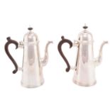 A pair of 20th century silver coffee pots, London 1971 by A Haviland-Nye, the domed lids with turned