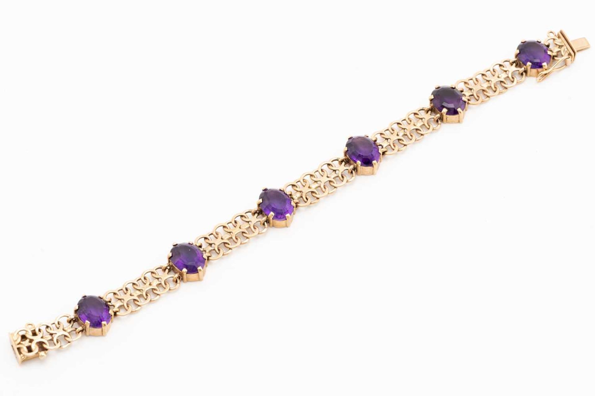 A bracelet set with amethysts in 9ct gold, comprising a wide bismarck link with six oval-cut - Image 2 of 5