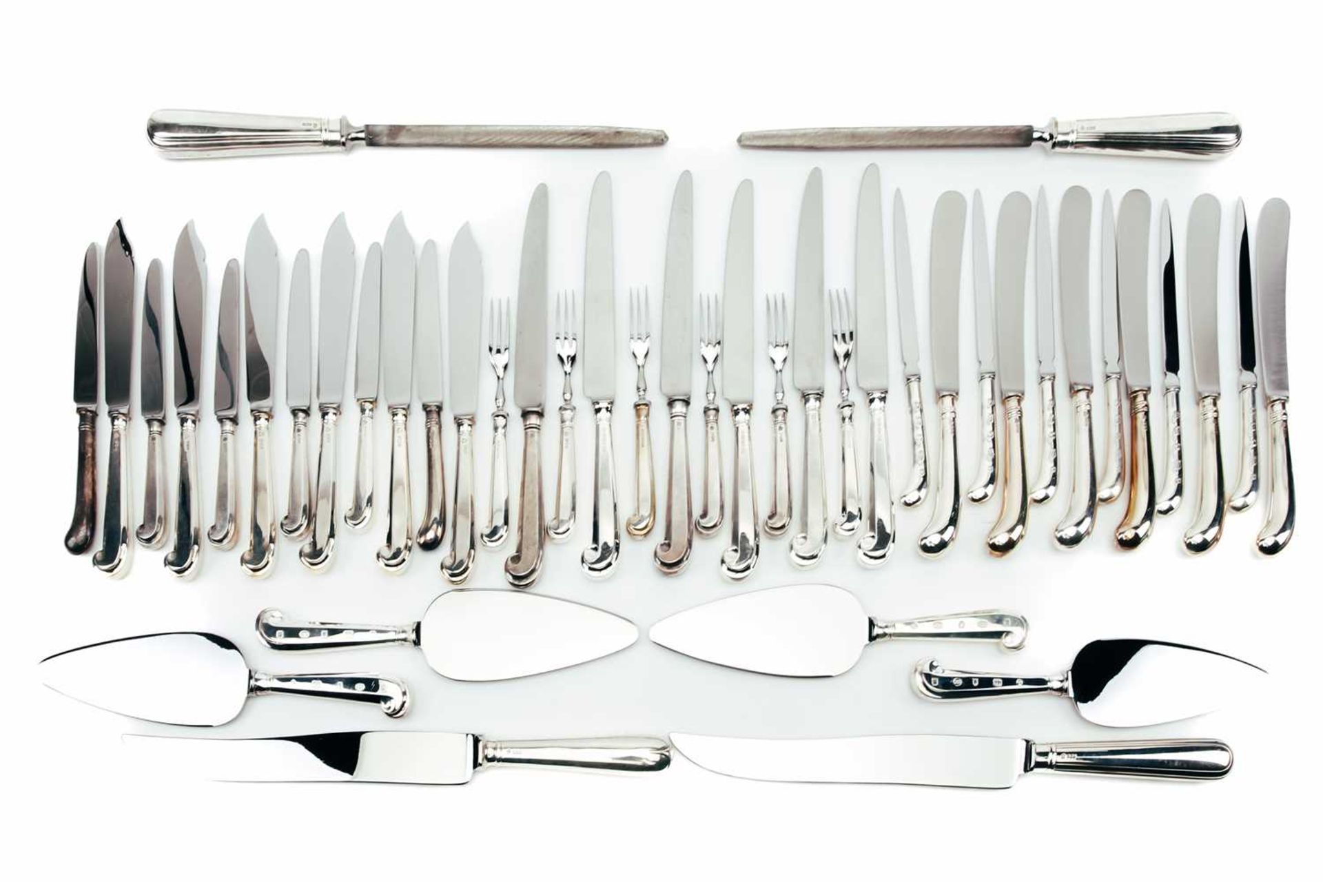 A mixed collection of modern silver-handled cutlery, including pistol grip dessert forks and various