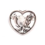 Georg Jensen - a heart-shaped brooch, depicting a flying dove with olive branches, fitted with a