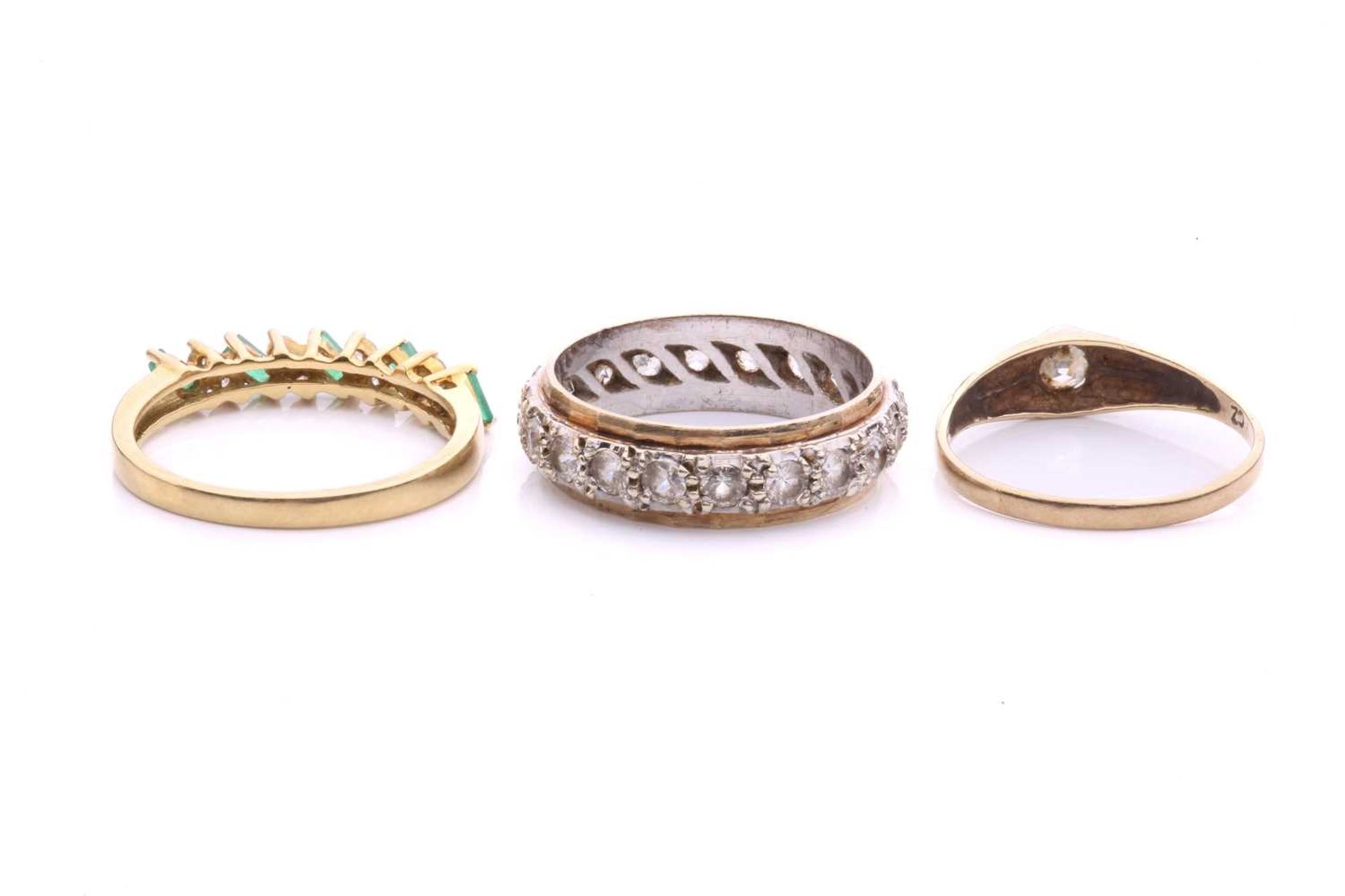 Three gem-set rings in gold; to include an 18ct gold ring set with alternating emeralds and - Image 4 of 4