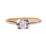 A single stone diamond ring; the round brilliant cut diamond in four claw mount between scalloped