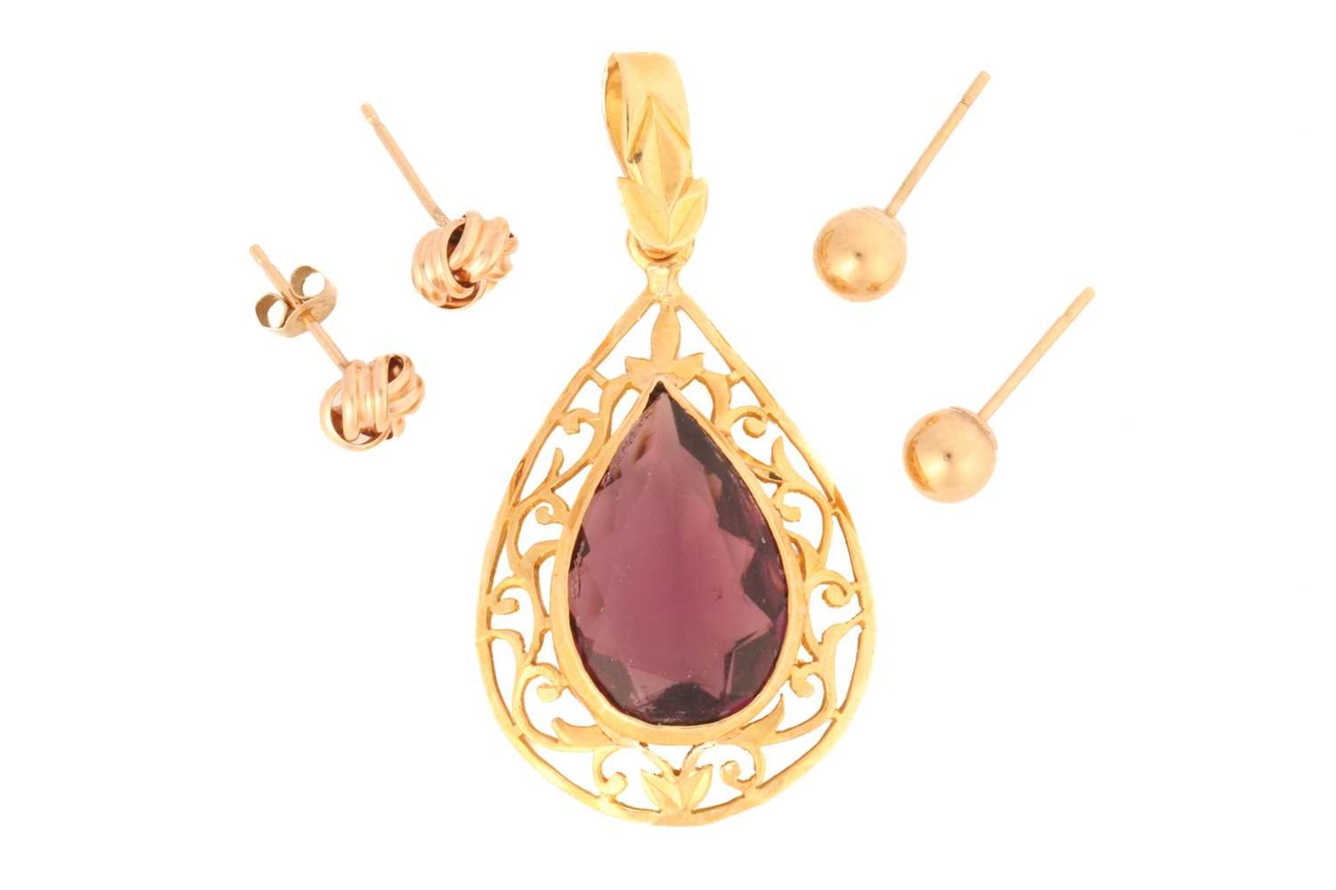 A purple paste pendant with two pairs of stud earrings; pendant comprising a pear-shaped purple
