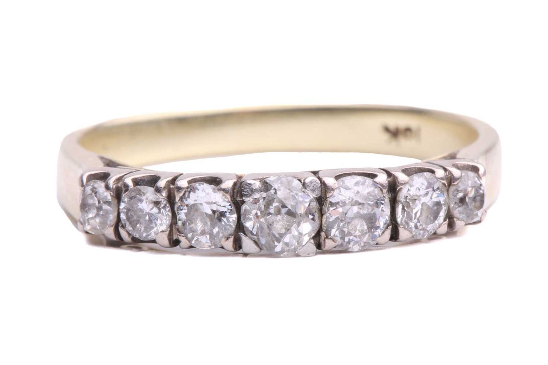 A seven stone half hoop ring; the slightly graduated mixed circular cut stones in squared claw