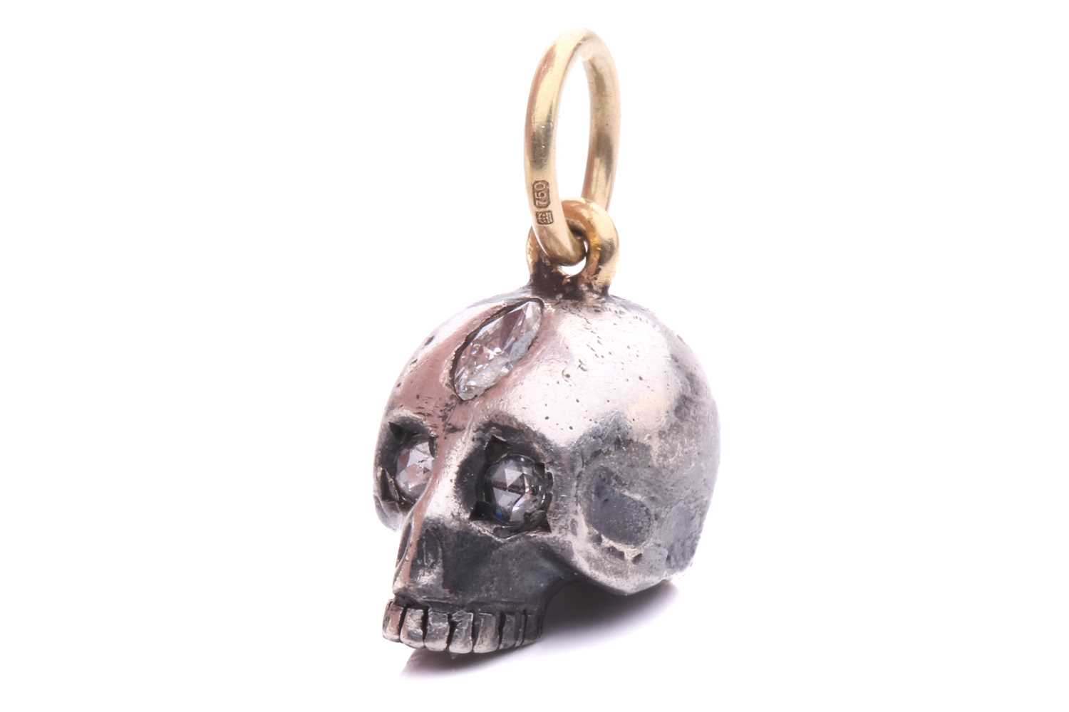 A diamond-set skull charm pendant in silver and 18ct gold, a sculpted hollow skull with eyes set - Image 2 of 6