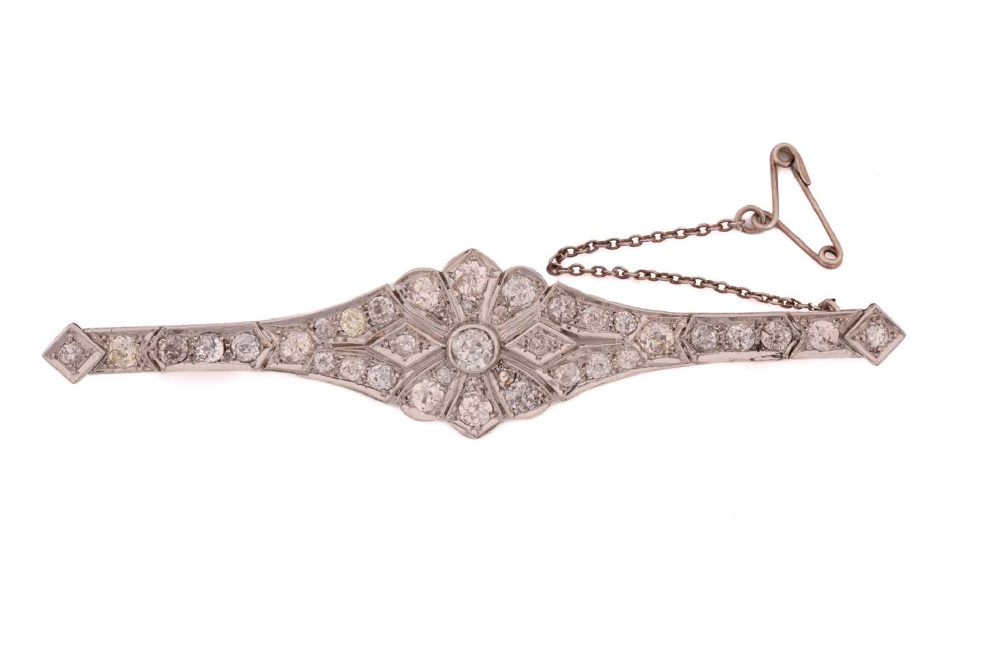 An Art Deco diamond bar brooch, of floral design, consisting of thirty-nine old-cut diamonds in - Image 2 of 3