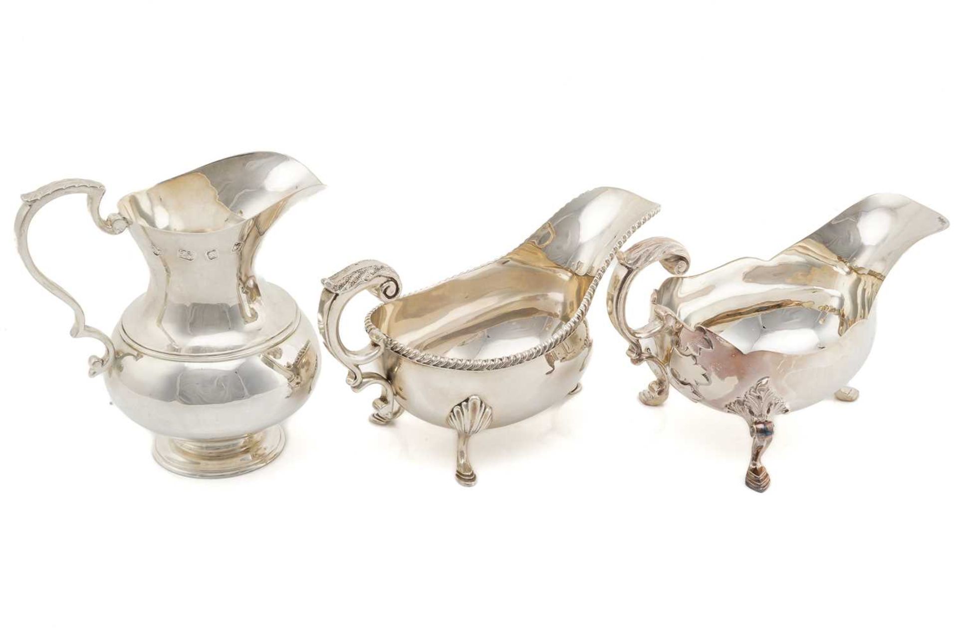 A matched pair of silver sauce boats, London 1969 and 1973 by A Haviland-Nye, one with a gadrooned