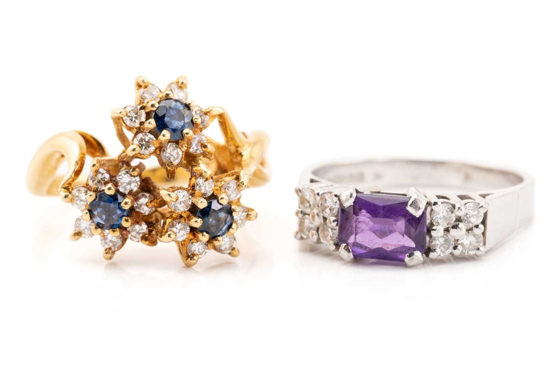 A triple cluster sapphire and diamond cluster ring, comprising three seven stone flower head