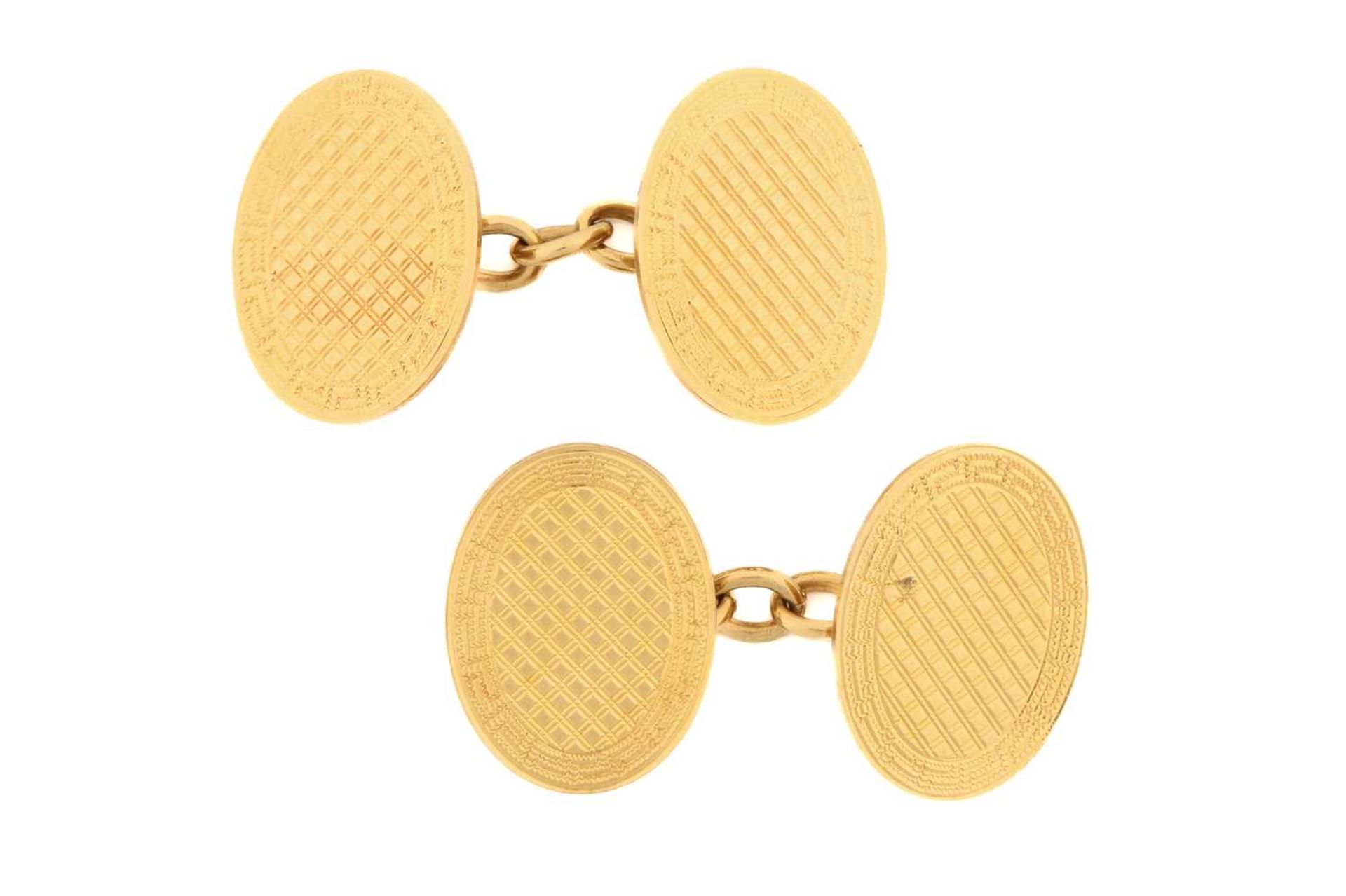 A pair of oval cufflinks, of lattice pattern with a Greek key border, connected with cable links,