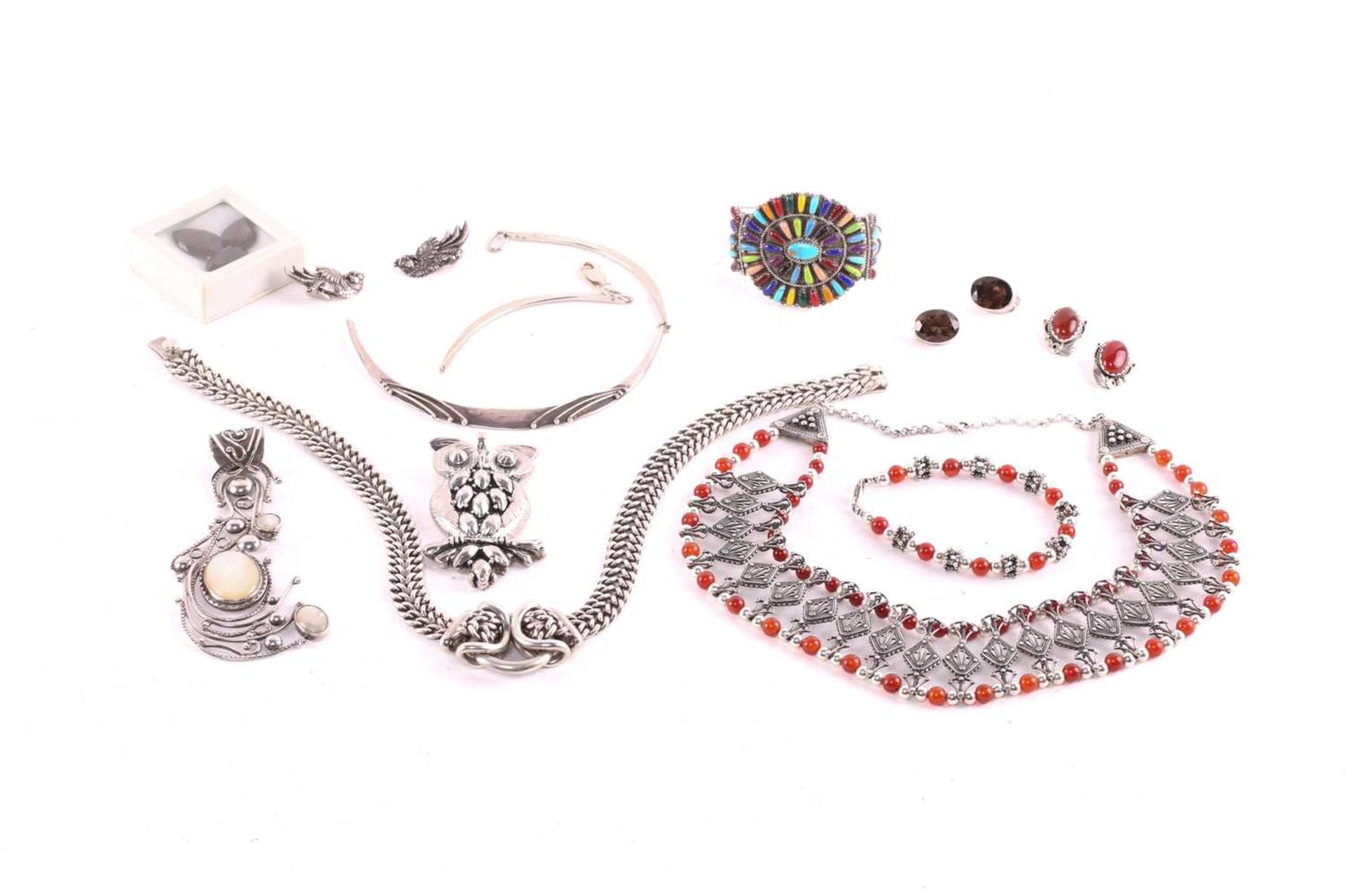A quantity of silver and white metal jewellery; including a Yemenite necklace, an owl pendant, a