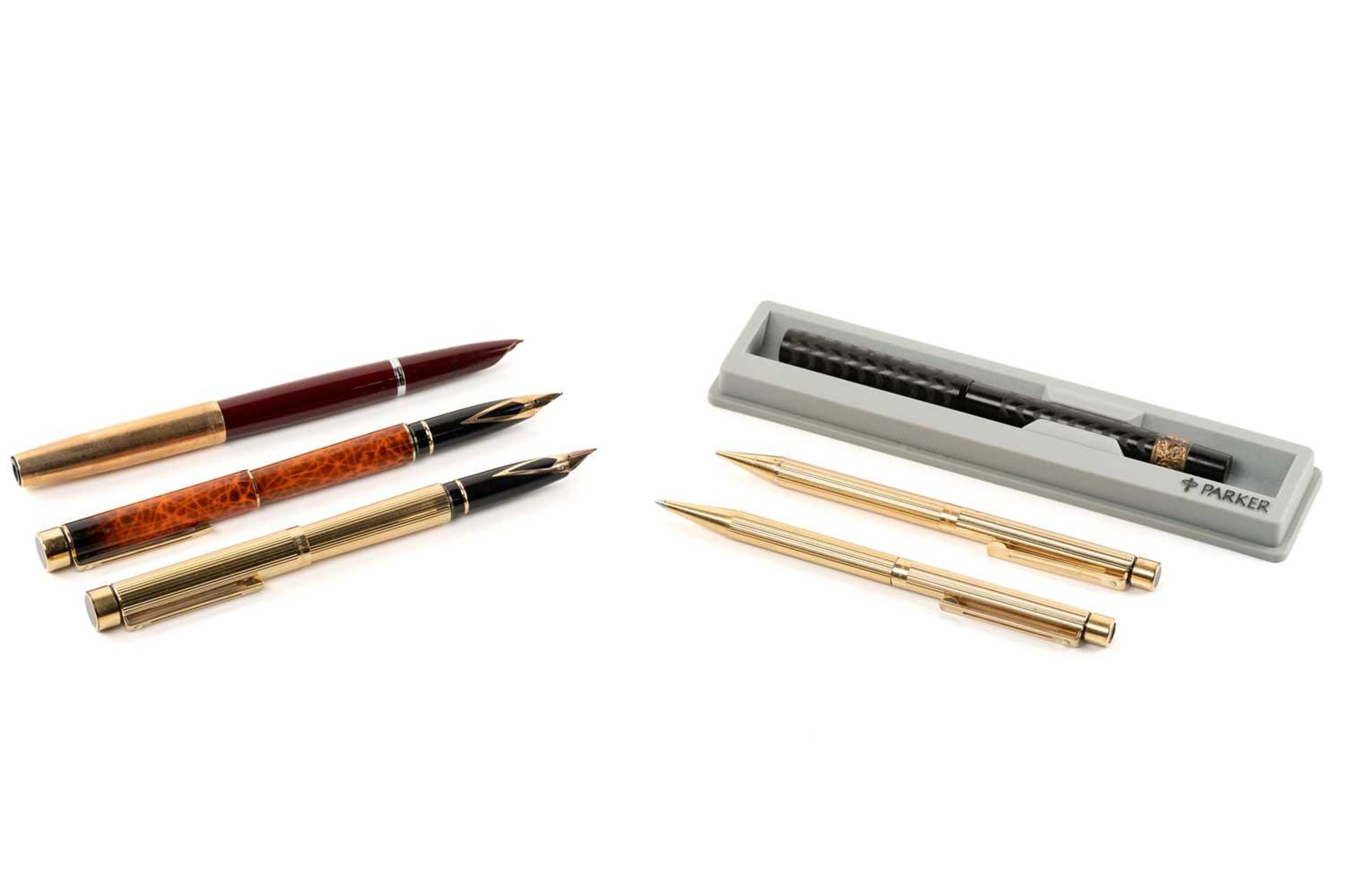 A group of six pens comprising a Sheaffer fountain pen with the nib marked 585, an early 20th