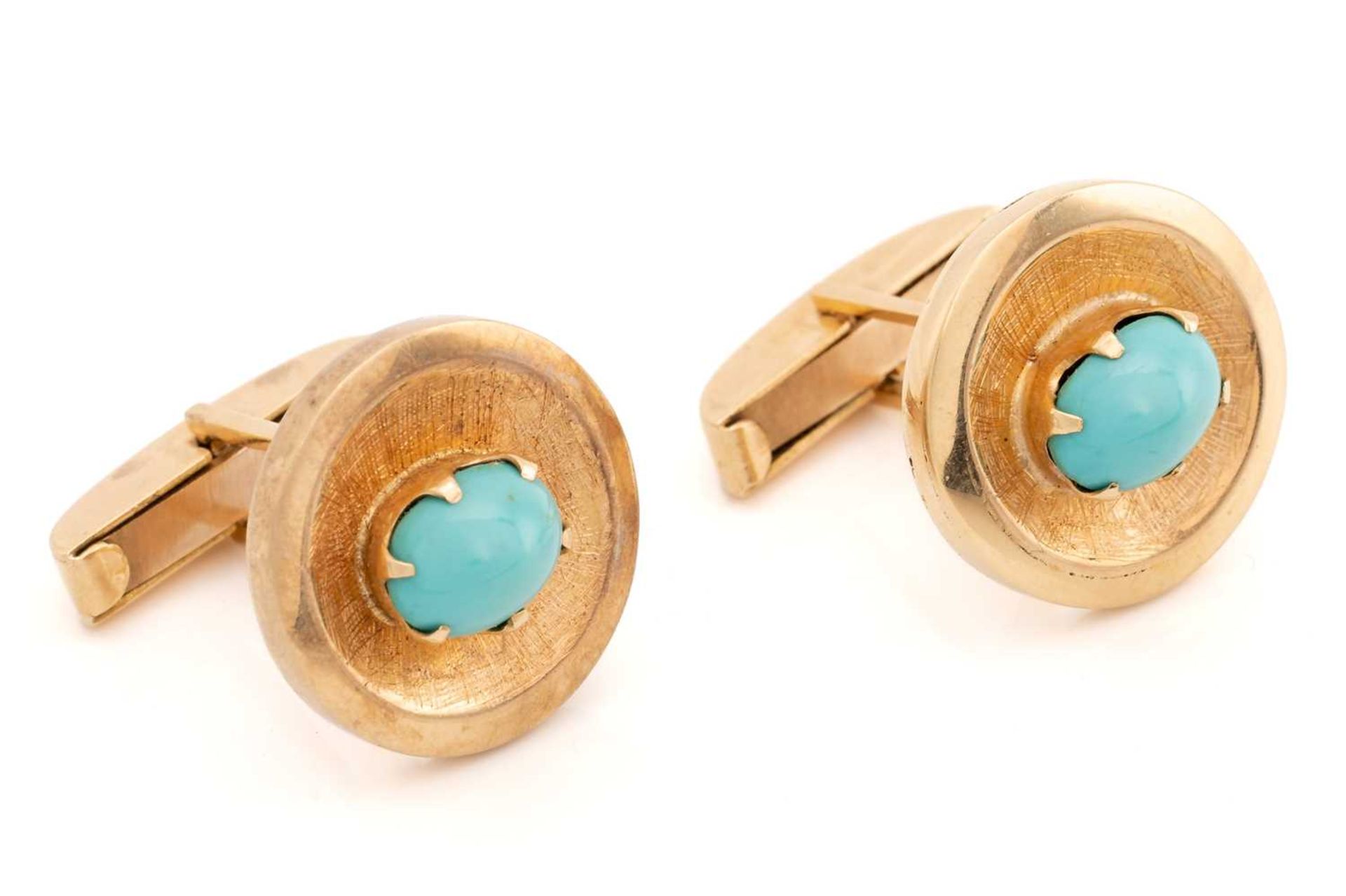 A pair of turquoise-set cufflinks, each featuring an oval Persian turquoise cabochon in claw
